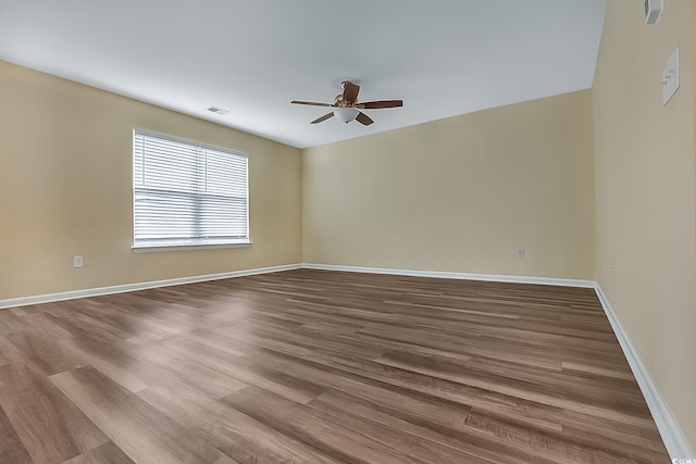 unfurnished room with hardwood / wood-style floors and ceiling fan