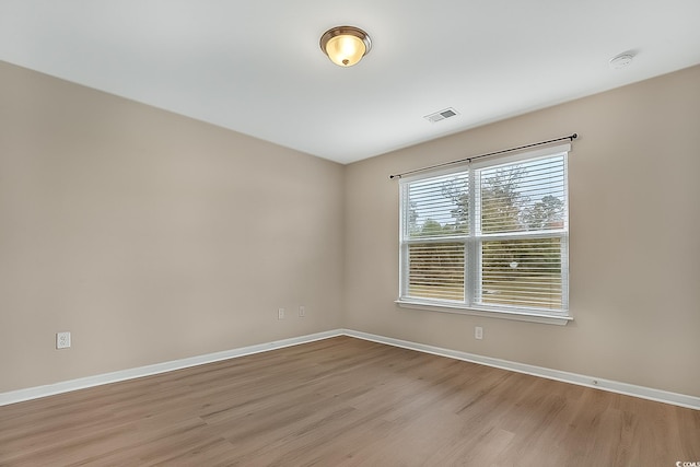 spare room with light hardwood / wood-style flooring