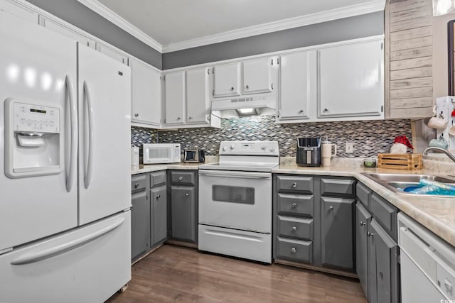 kitchen featuring white appliances, ventilation hood, gray cabinets, ornamental molding, and dark hardwood / wood-style flooring