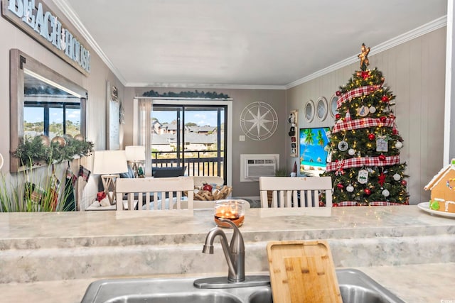 kitchen with a wall unit AC, crown molding, and a wealth of natural light