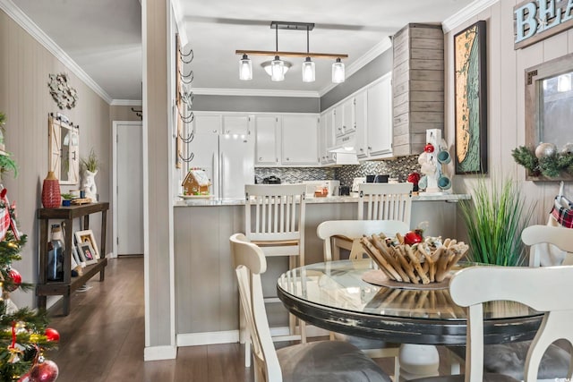 dining area featuring dark hardwood / wood-style floors and ornamental molding