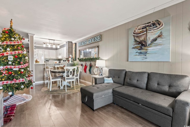 living room with hardwood / wood-style floors and crown molding