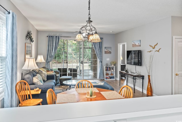 living room featuring hardwood / wood-style floors, a notable chandelier, and a textured ceiling