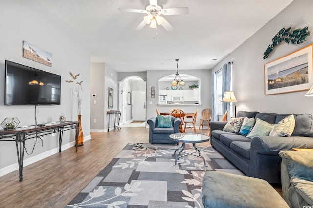 living room with hardwood / wood-style flooring and ceiling fan