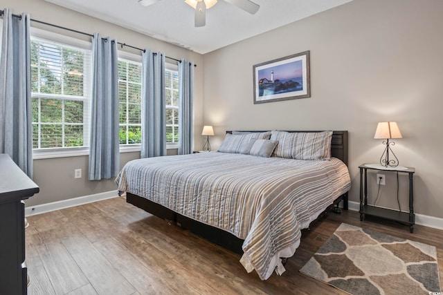 bedroom with wood-type flooring and ceiling fan