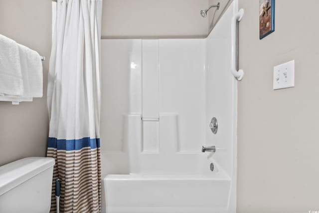 bathroom featuring toilet and shower / tub combo with curtain