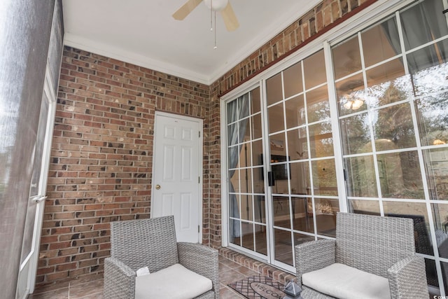 unfurnished sunroom featuring ceiling fan