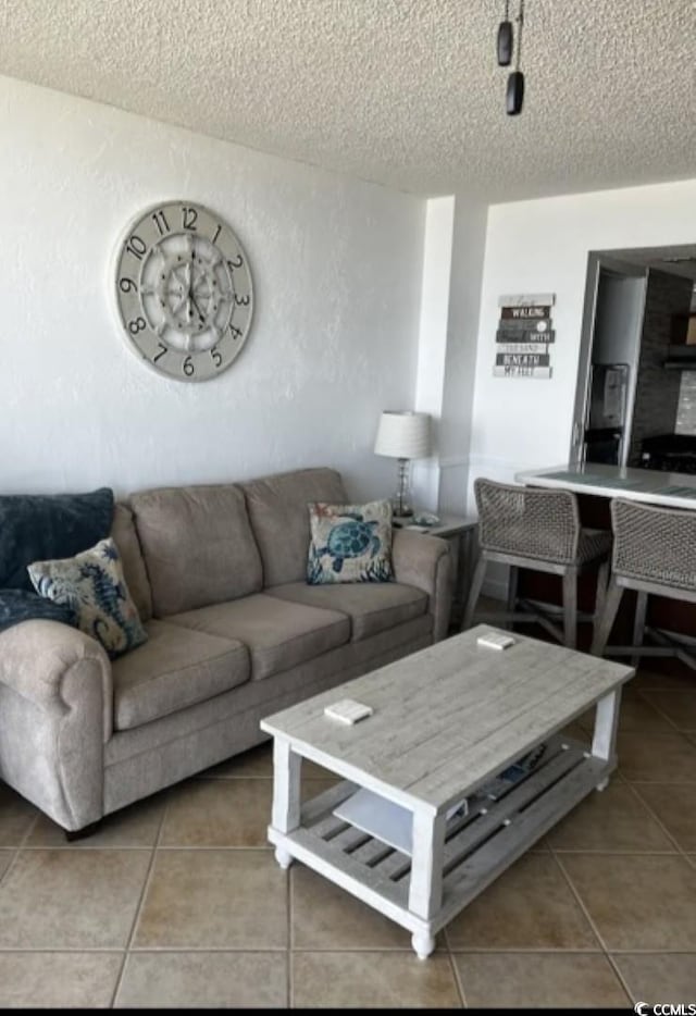 tiled living room featuring a textured ceiling