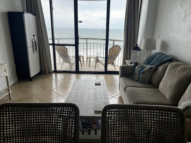 living room with a water view and light tile patterned flooring