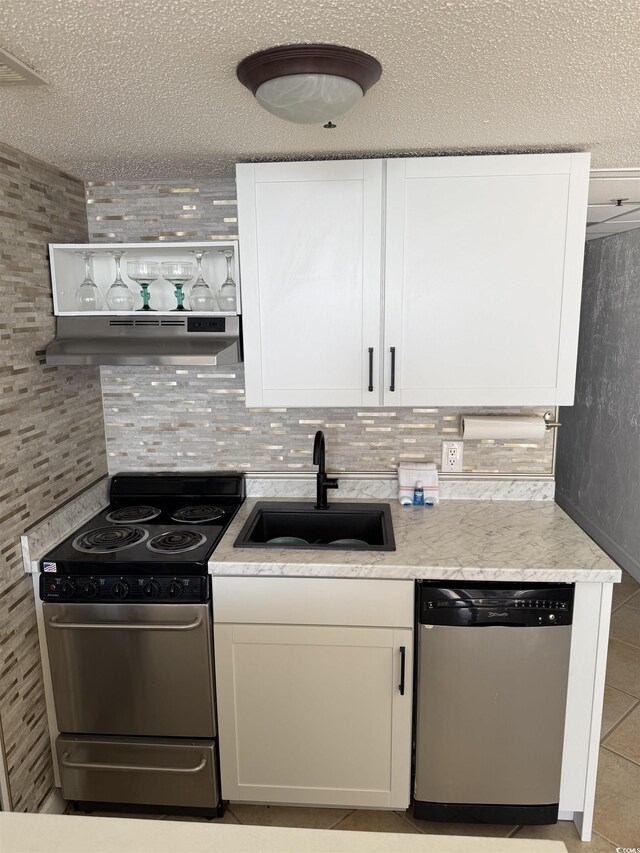 kitchen featuring sink, stainless steel appliances, tasteful backsplash, and white cabinetry