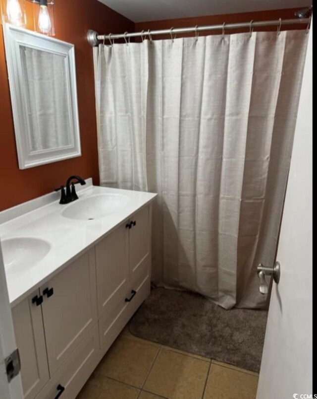 bathroom with vanity and tile patterned flooring