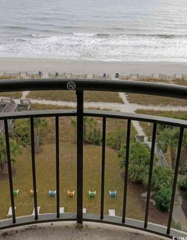 balcony featuring a beach view and a water view