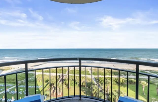 balcony with a beach view and a water view