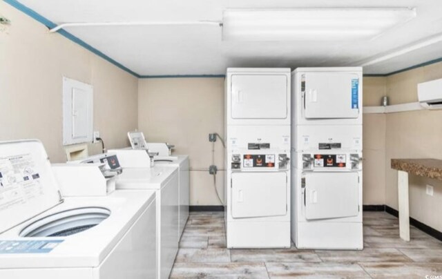 washroom featuring light hardwood / wood-style floors, stacked washer / dryer, and independent washer and dryer