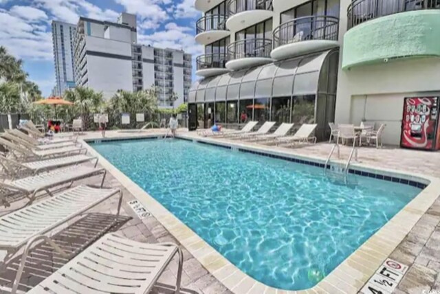 view of swimming pool with a patio