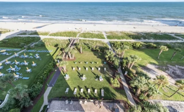 birds eye view of property with a water view and a view of the beach