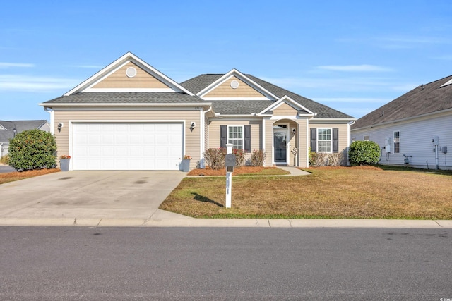 view of front of property with a garage and a front yard