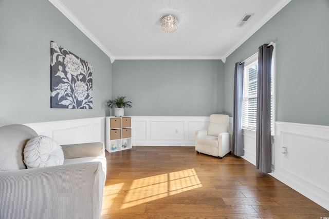 living area featuring dark hardwood / wood-style floors and crown molding