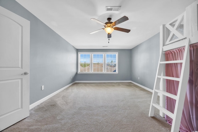 empty room featuring light carpet and ceiling fan