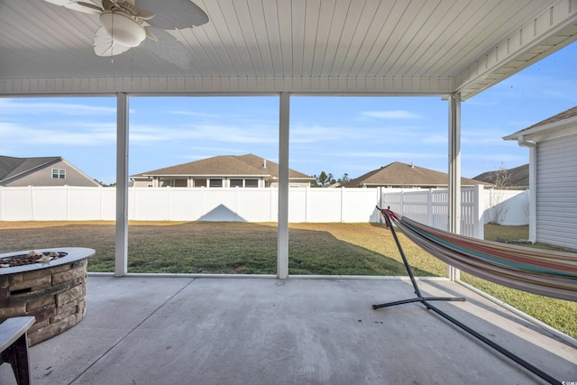 unfurnished sunroom with ceiling fan