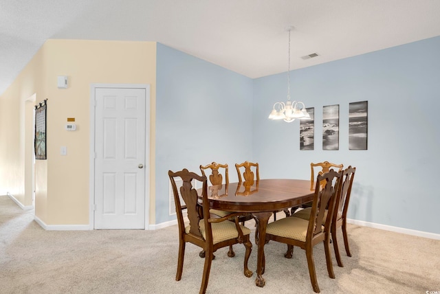 dining room with an inviting chandelier, baseboards, visible vents, and light colored carpet