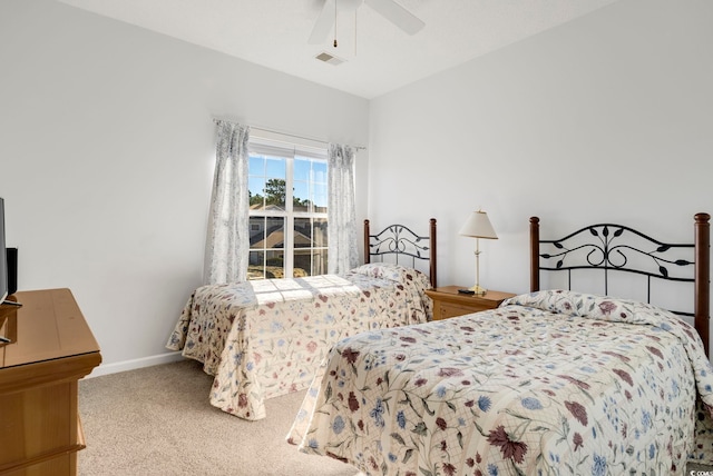 bedroom with a ceiling fan, light colored carpet, visible vents, and baseboards