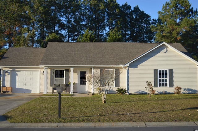 view of front of property featuring a front yard and a garage