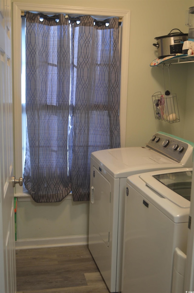 laundry area with washer and dryer and dark hardwood / wood-style floors