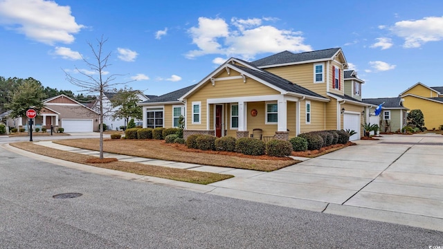 craftsman inspired home featuring a garage, a residential view, and concrete driveway