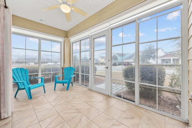 unfurnished sunroom with ceiling fan and visible vents