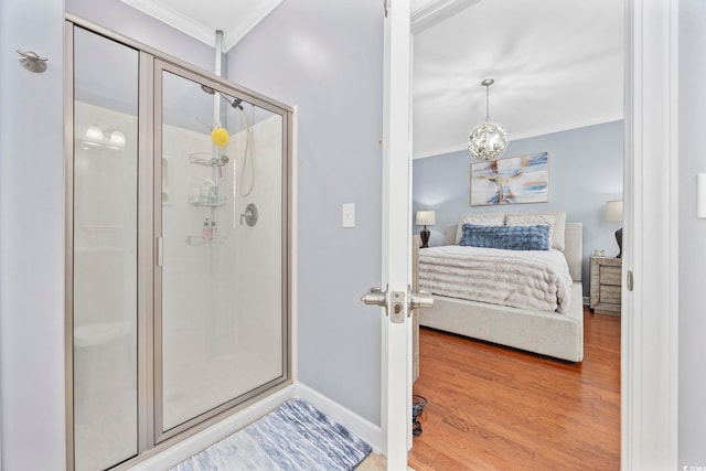 bedroom with light wood-type flooring, baseboards, and ornamental molding