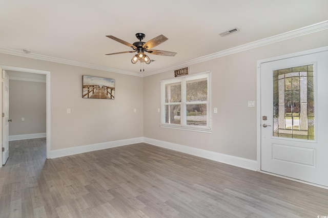 entrance foyer with ceiling fan, ornamental molding, and light wood-type flooring