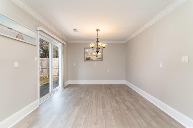 unfurnished dining area with crown molding, a chandelier, and light wood-type flooring