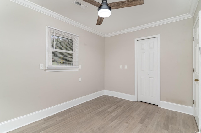 unfurnished bedroom with ceiling fan, ornamental molding, a closet, and light hardwood / wood-style flooring