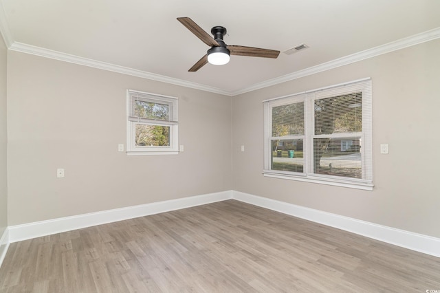 empty room with ornamental molding, ceiling fan, and light hardwood / wood-style flooring