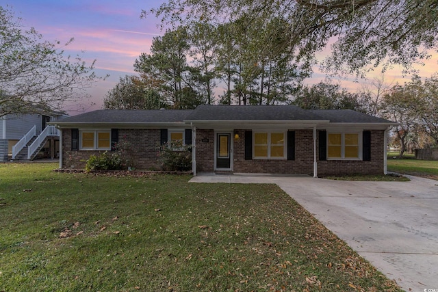 ranch-style house with a yard