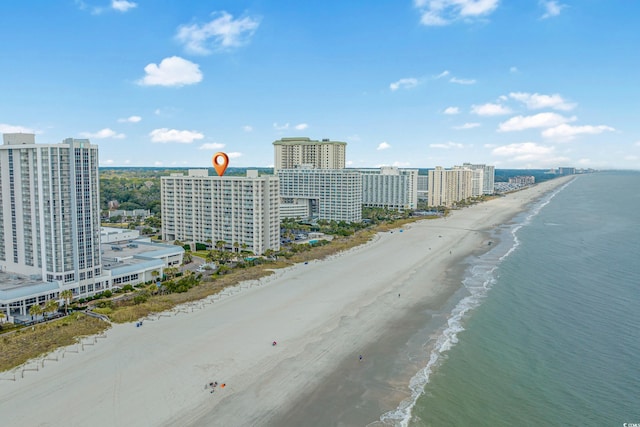 birds eye view of property featuring a water view and a beach view