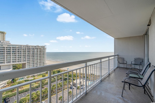 balcony featuring a water view and a beach view