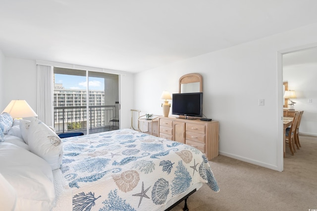 bedroom featuring light colored carpet and access to outside