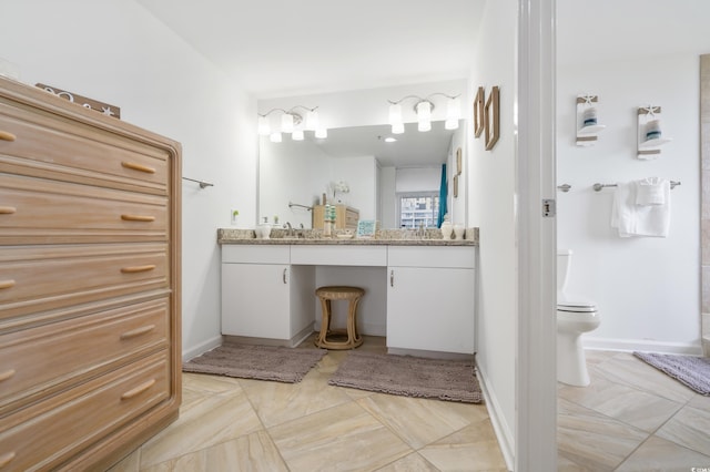 bathroom featuring vanity and toilet