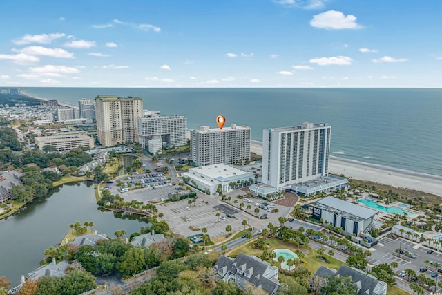 drone / aerial view featuring a water view and a beach view