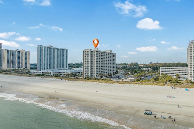 drone / aerial view featuring a view of the beach and a water view