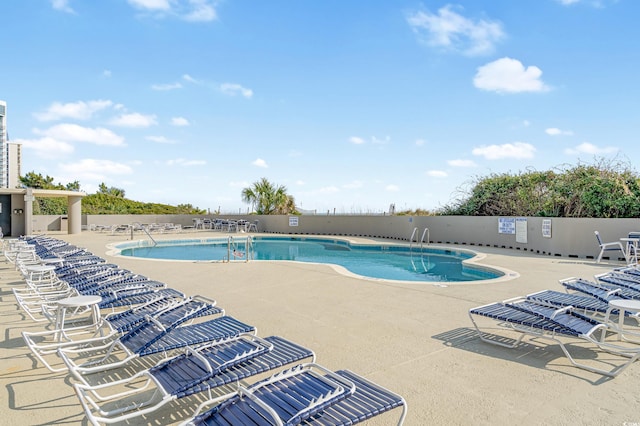 view of swimming pool with a patio