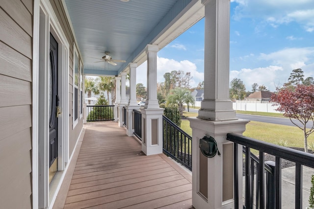 wooden terrace featuring ceiling fan and a porch