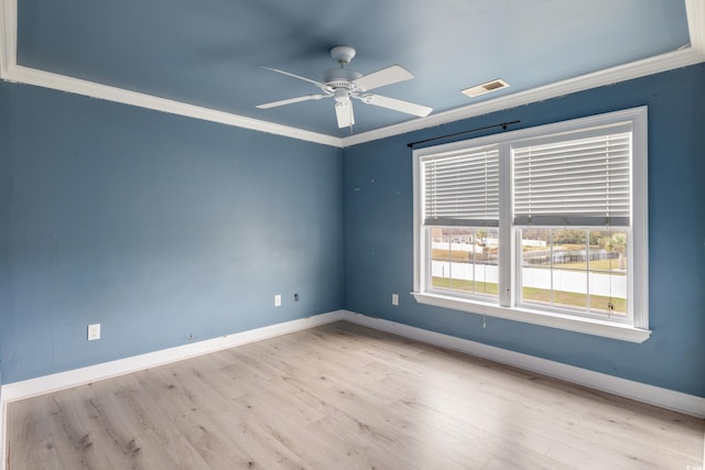 unfurnished room featuring ornamental molding, ceiling fan, light wood-style flooring, and baseboards