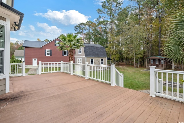 deck featuring an outbuilding and a lawn