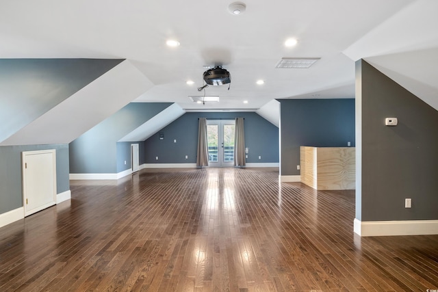 bonus room with lofted ceiling, recessed lighting, baseboards, french doors, and dark wood-style floors