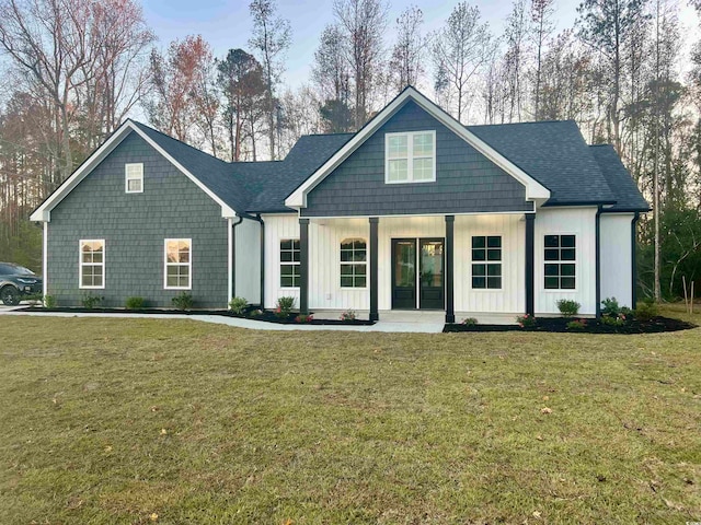 view of front of property with a porch and a front lawn