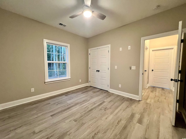 unfurnished bedroom featuring ceiling fan and light hardwood / wood-style floors