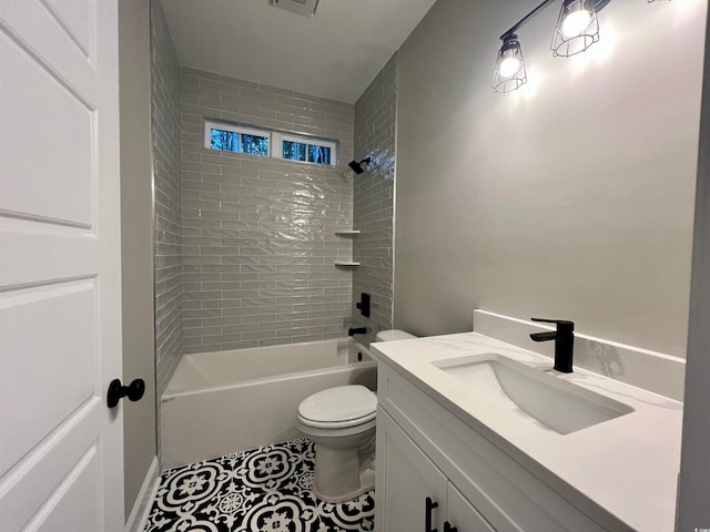 full bathroom with vanity, tile patterned floors, tiled shower / bath combo, and toilet